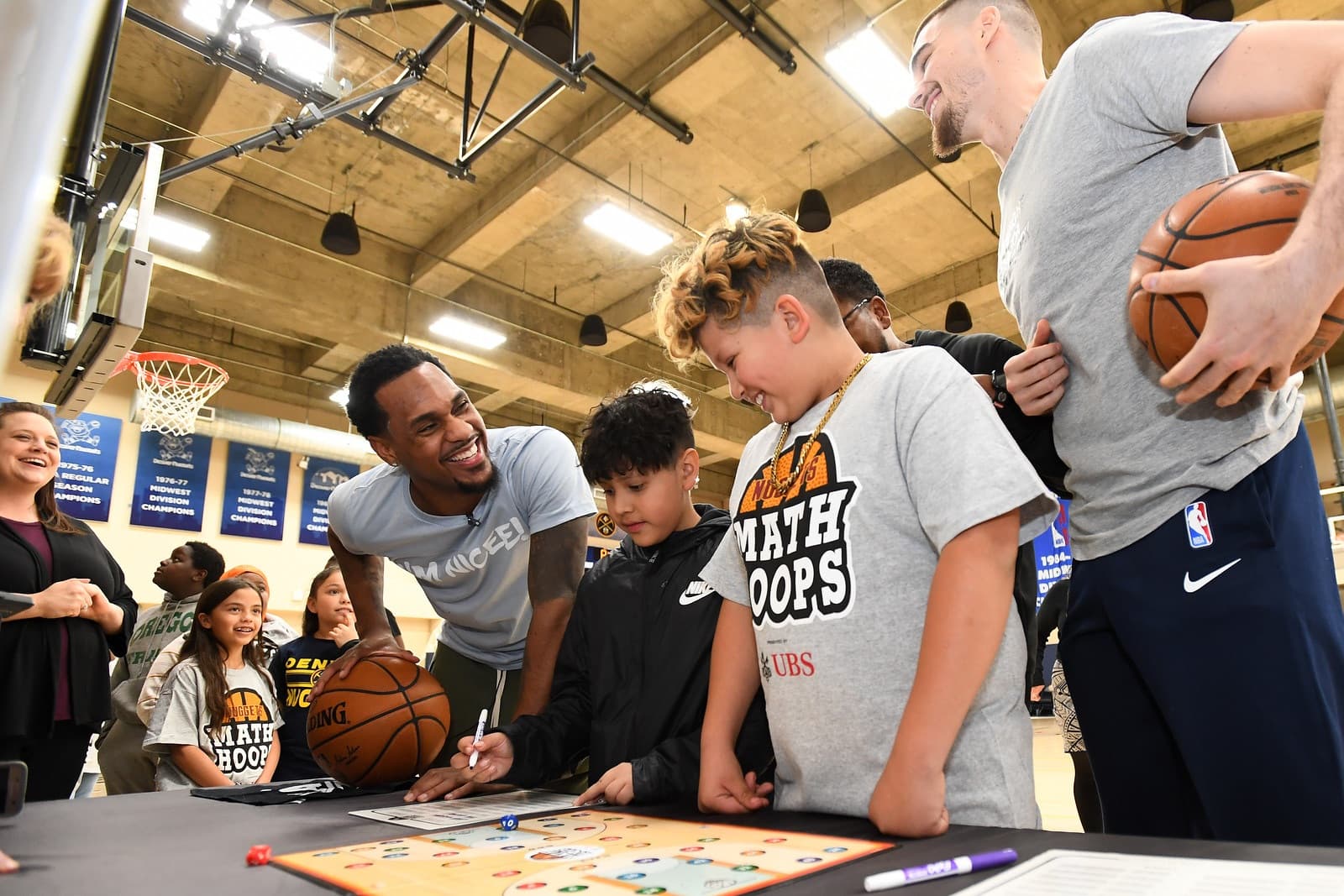 Basketball players with students
